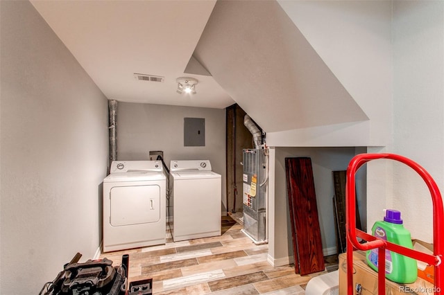 laundry room featuring light wood finished floors, visible vents, electric panel, laundry area, and washer and dryer