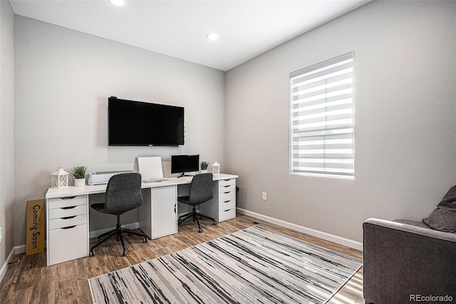 office area with baseboards, light wood finished floors, and recessed lighting