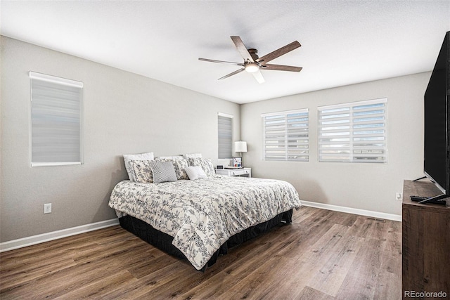 bedroom with baseboards, a ceiling fan, and wood finished floors