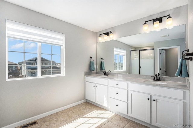 full bathroom with a shower stall, baseboards, a sink, and visible vents