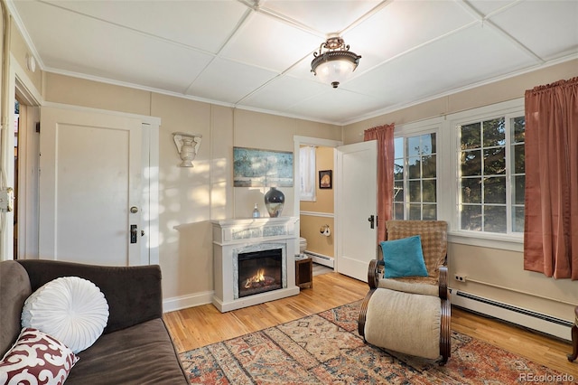 living room with crown molding, hardwood / wood-style floors, and a baseboard radiator