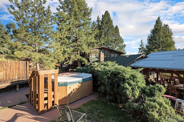 exterior space featuring a hot tub and a gazebo