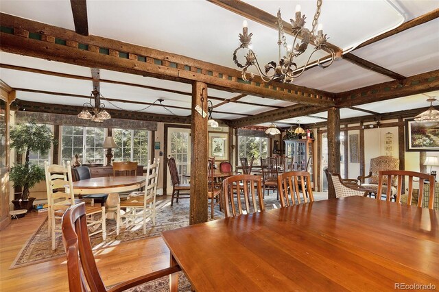 dining area featuring beamed ceiling, a notable chandelier, and light wood-type flooring