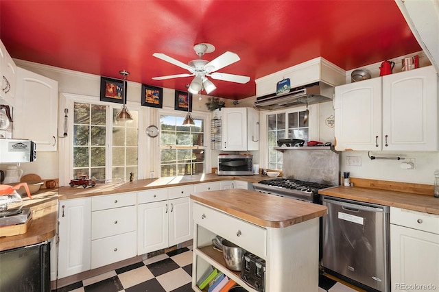 kitchen with stainless steel appliances, wood counters, pendant lighting, white cabinetry, and ceiling fan