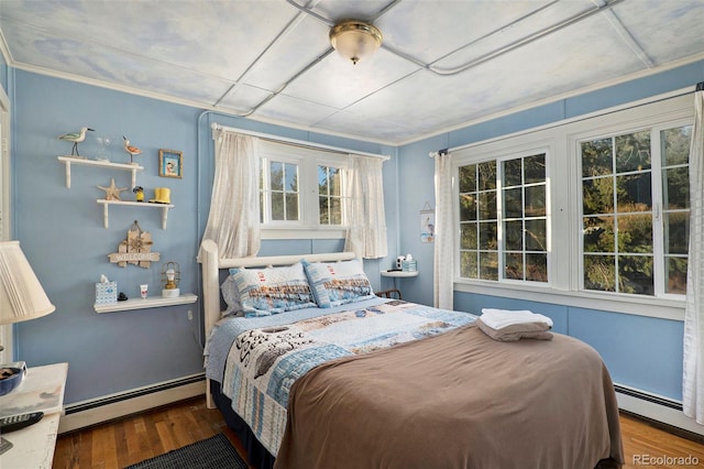 bedroom with a baseboard radiator, ornamental molding, and wood-type flooring