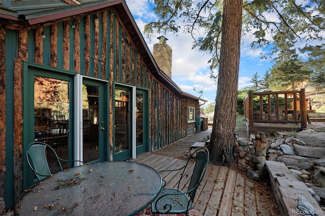 27425 Spruce Ln, Evergreen, CO 80439 - wooden deck featuring outdoor dining area