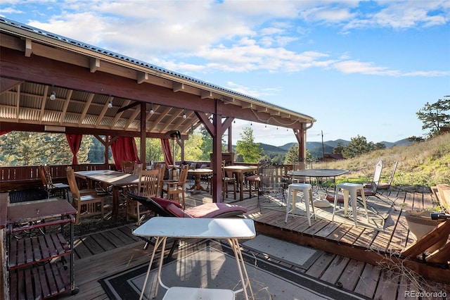 27425 Spruce Ln, Evergreen, CO 80439 - wooden deck featuring outdoor dining area and a mountain view