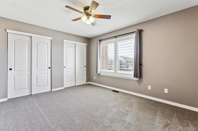 1328 Double Eagle Ct, Castle Rock, CO 80104 - unfurnished bedroom featuring two closets, carpet flooring, and a ceiling fan