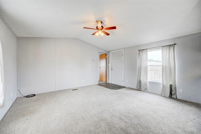 spare room featuring a ceiling fan, lofted ceiling, and carpet floors