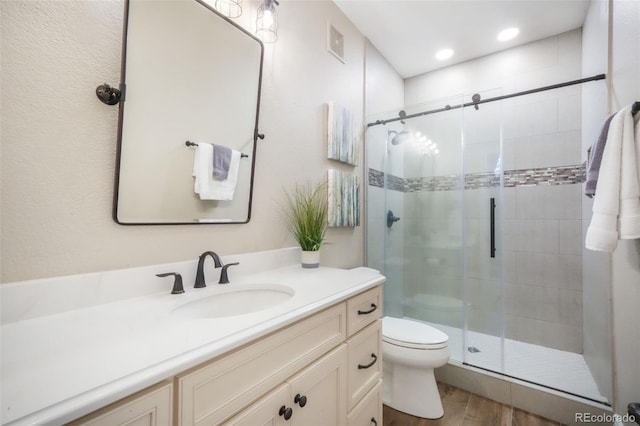 16092 Waving Branch Way, Colorado Springs, CO 80908 - full bath with wood finished floors, a shower stall, toilet, and vanity