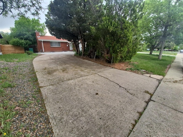 387 Tucson St, Aurora, CO 80011 - view of front of property with driveway and brick siding