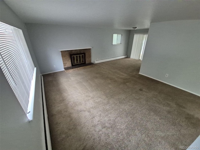 387 Tucson St, Aurora, CO 80011 - unfurnished living room with a baseboard radiator, carpet floors, baseboards, and a glass covered fireplace