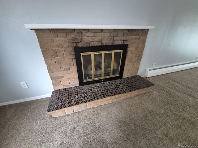 387 Tucson St, Aurora, CO 80011 - detailed view of a baseboard radiator, carpet, a glass covered fireplace, and baseboards