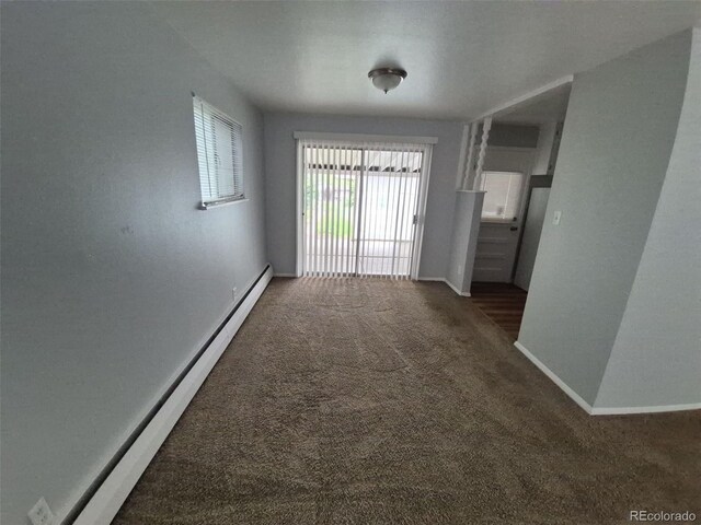 387 Tucson St, Aurora, CO 80011 - carpeted empty room with baseboards and a baseboard heating unit