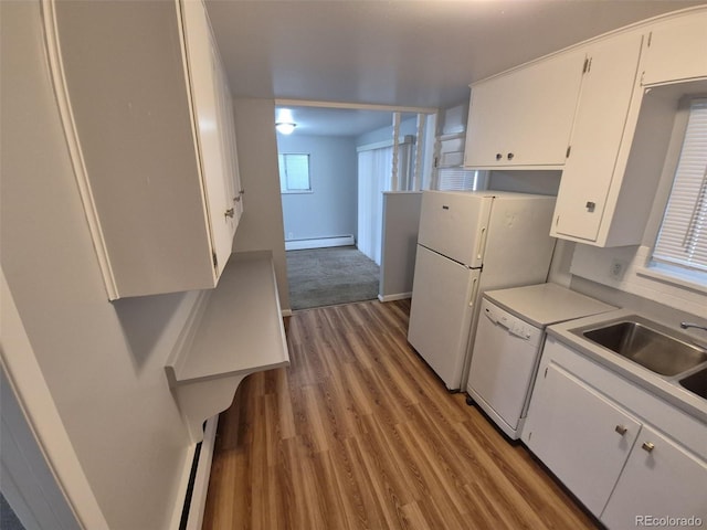 387 Tucson St, Aurora, CO 80011 - kitchen with a baseboard radiator, white cabinets, light wood-style flooring, white dishwasher, and light countertops