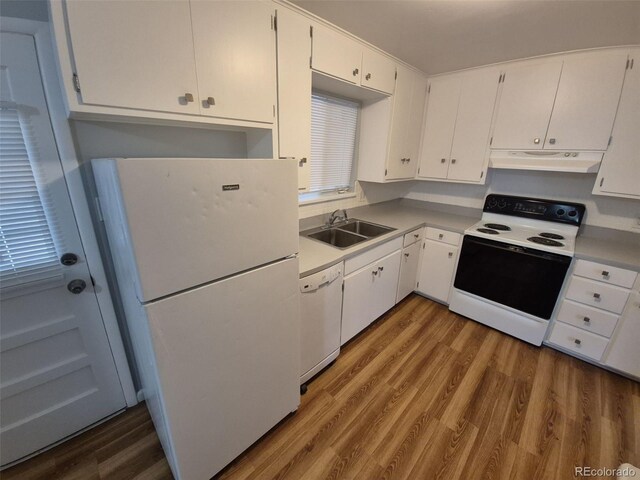 387 Tucson St, Aurora, CO 80011 - kitchen with white appliances, under cabinet range hood, a sink, and wood finished floors