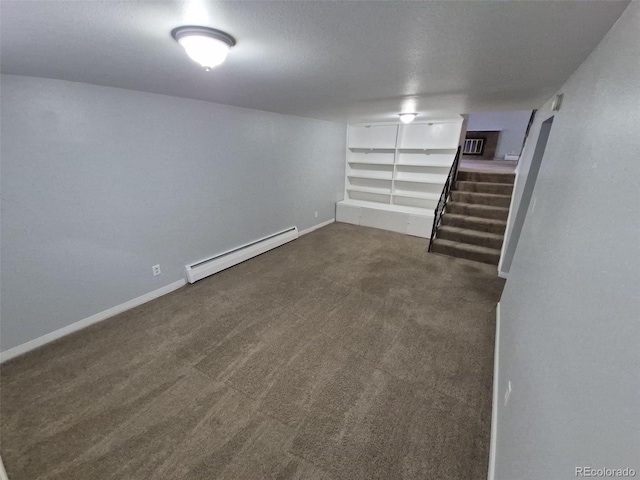 387 Tucson St, Aurora, CO 80011 - finished below grade area featuring baseboard heating, stairs, carpet flooring, and baseboards