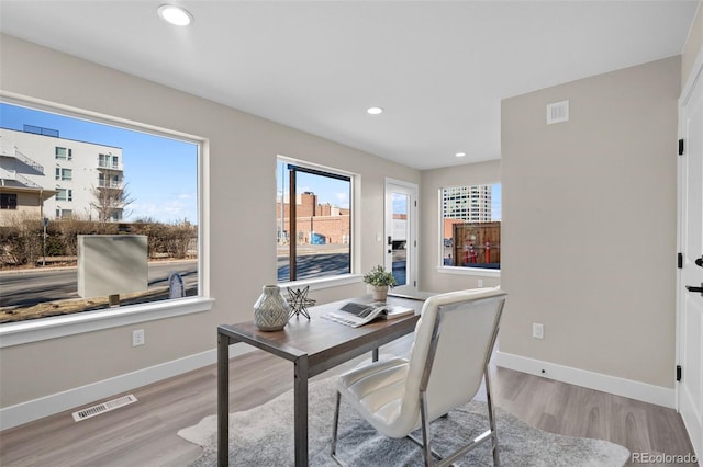 office area with recessed lighting, visible vents, light wood-style flooring, and baseboards