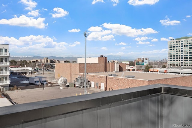 balcony featuring a mountain view and a city view