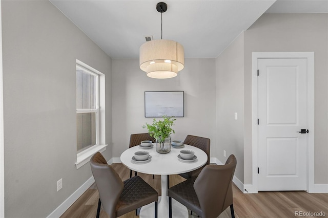 dining area featuring baseboards, visible vents, and light wood-type flooring