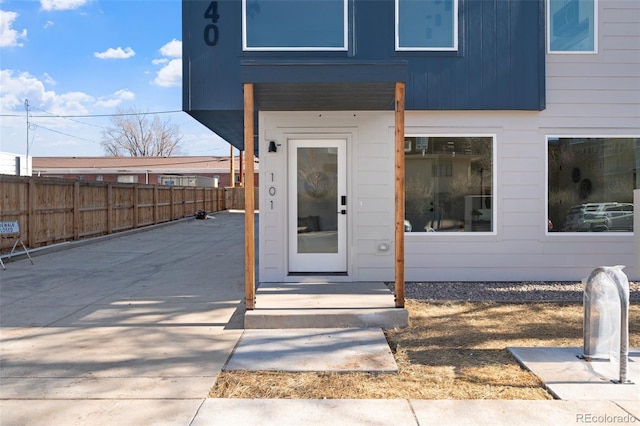 doorway to property featuring fence
