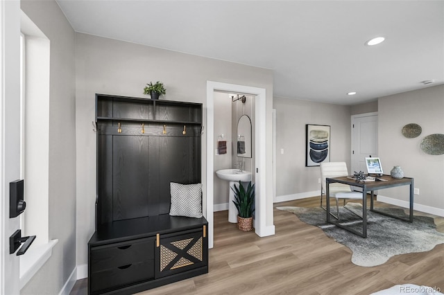 interior space featuring baseboards, recessed lighting, and light wood-type flooring
