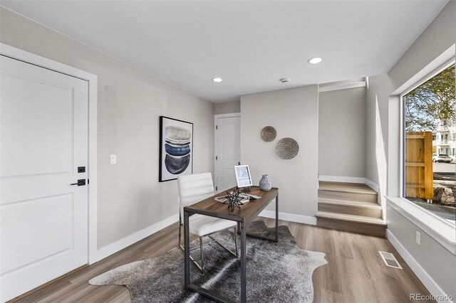 home office with baseboards, recessed lighting, wood finished floors, and visible vents
