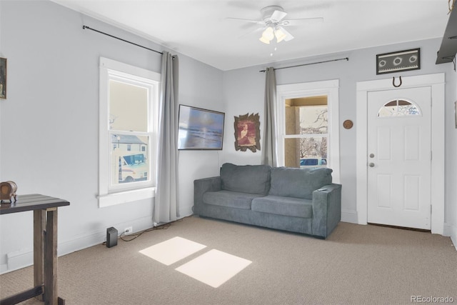 carpeted living room with a healthy amount of sunlight and ceiling fan