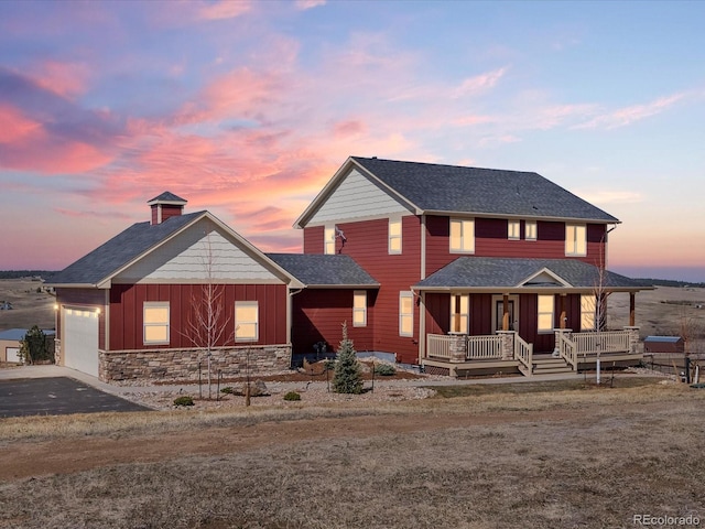 34698 Southern Cross Loop, Kiowa, CO 80117 - view of front of house with a porch, a garage, board and batten siding, driveway, and stone siding
