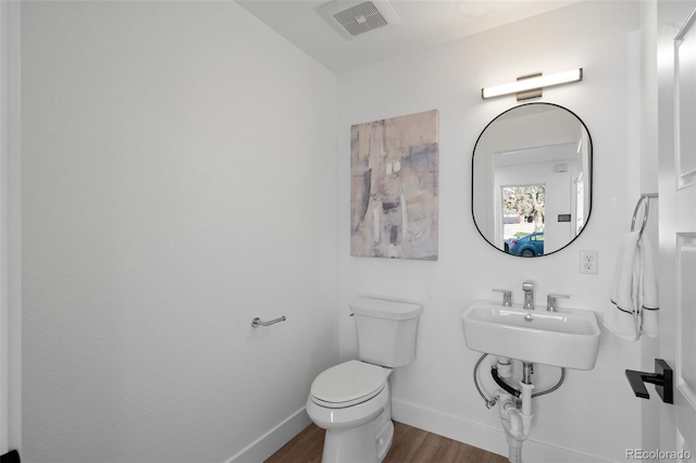 bathroom with toilet and wood-type flooring