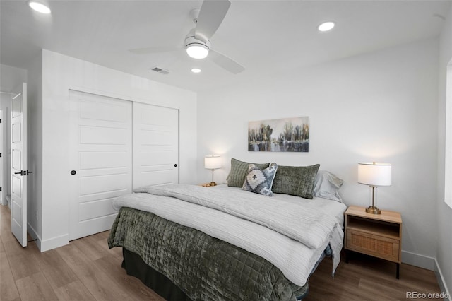 bedroom featuring wood-type flooring, a closet, and ceiling fan