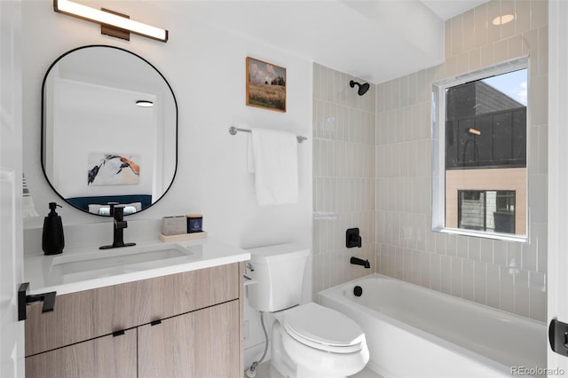 full bathroom featuring tiled shower / bath combo, toilet, and vanity