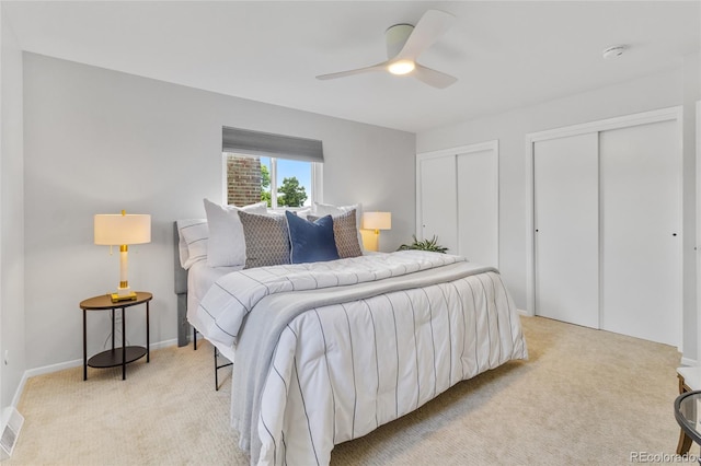 4650 S Idalia St, Aurora, CO 80015 - bedroom featuring light carpet, two closets, ceiling fan, and baseboards