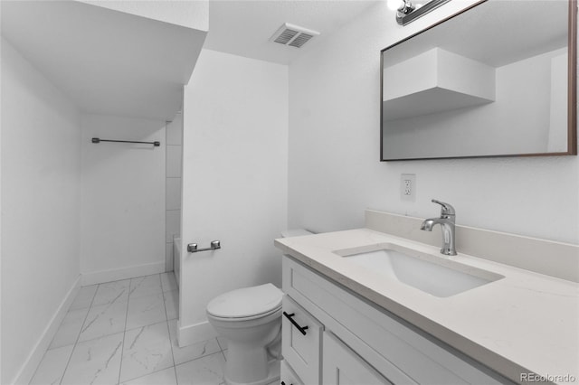 4650 S Idalia St, Aurora, CO 80015 - bathroom with marble finish floors, toilet, vanity, and baseboards