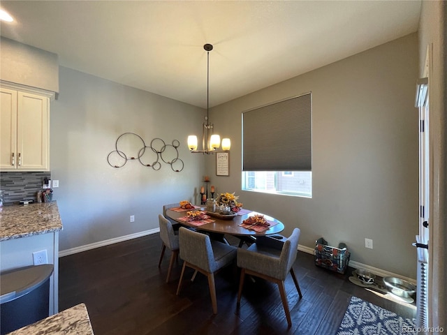 dining area featuring a notable chandelier and dark hardwood / wood-style flooring