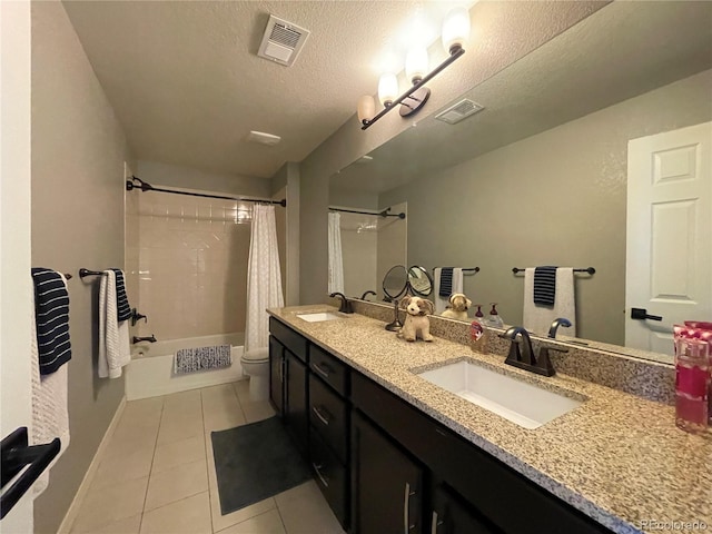 full bathroom featuring a textured ceiling, toilet, vanity, shower / tub combo with curtain, and tile patterned flooring