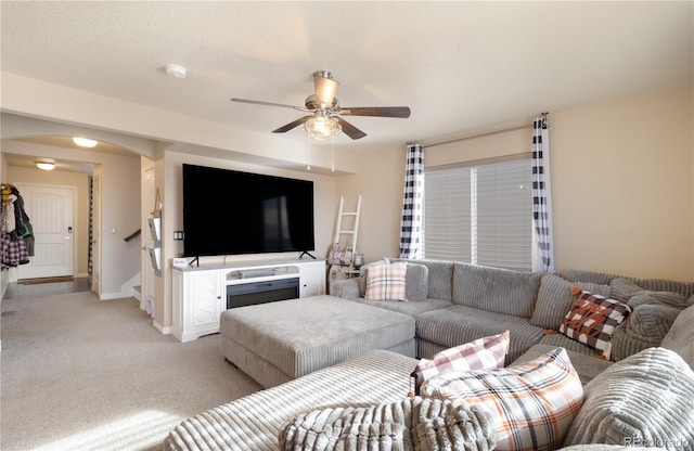 carpeted living room featuring ceiling fan