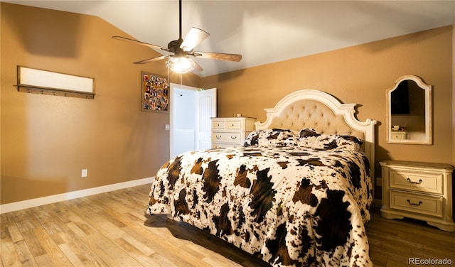 bedroom with ceiling fan, light wood-type flooring, and lofted ceiling