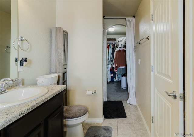 bathroom featuring tile patterned flooring, vanity, and toilet