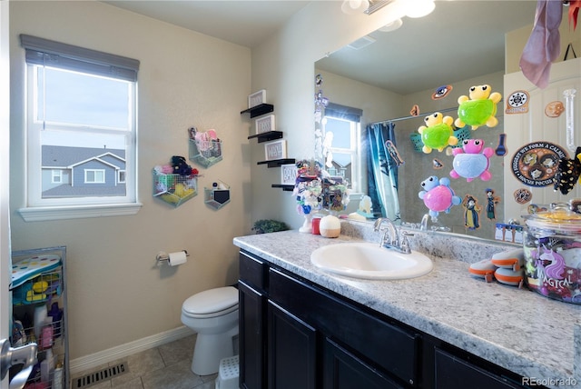 bathroom featuring tile patterned flooring, vanity, curtained shower, and toilet