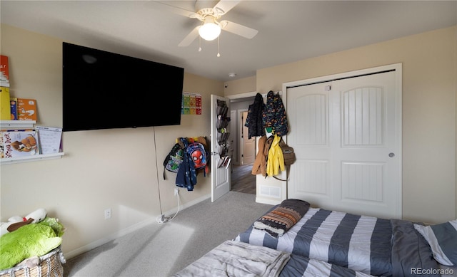 bedroom with ceiling fan, a closet, and carpet floors