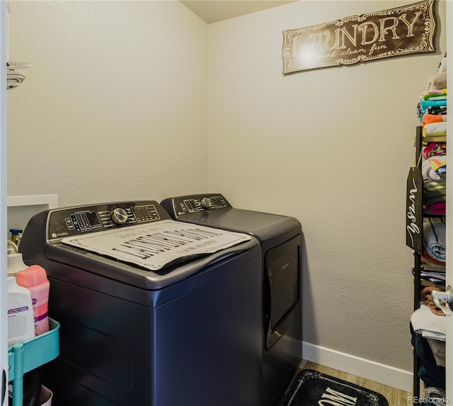 clothes washing area featuring independent washer and dryer