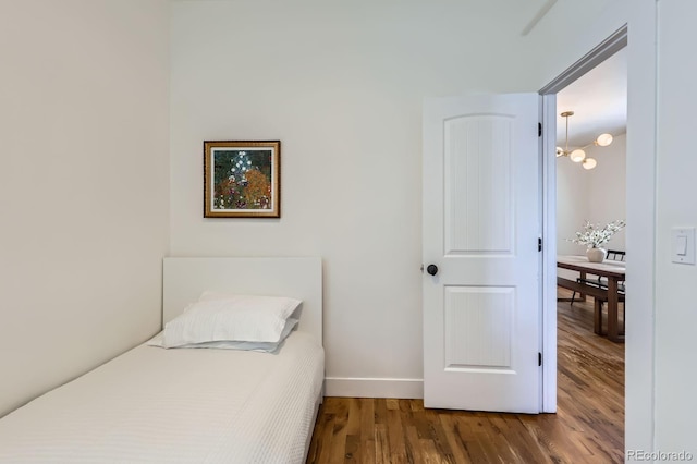 bedroom with baseboards and wood finished floors