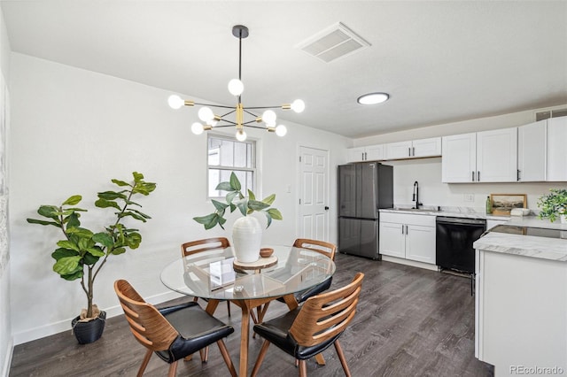 1330 Oak Pl, Thornton, CO 80229 - dining room with dark wood finished floors, a chandelier, and baseboards