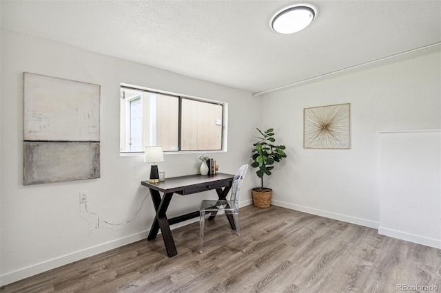 1330 Oak Pl, Thornton, CO 80229 - office area featuring wood finished floors, baseboards, and a textured ceiling