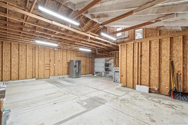 1330 Oak Pl, Thornton, CO 80229 - basement featuring a garage and stainless steel fridge with ice dispenser