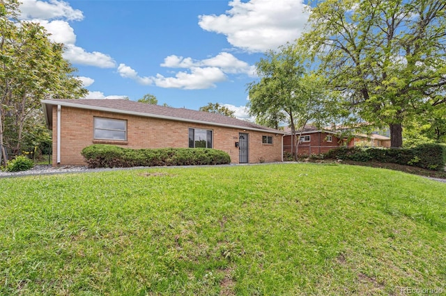 1330 Oak Pl, Thornton, CO 80229 - view of front facade featuring brick siding and a front lawn