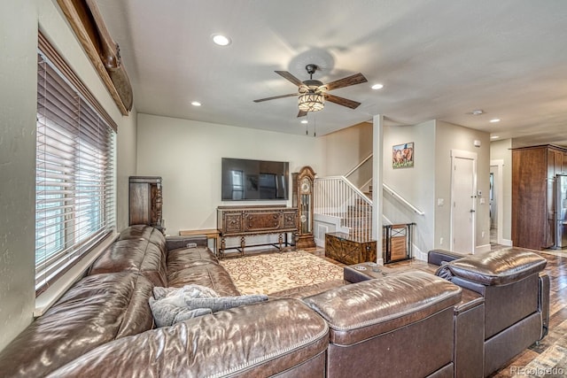 living room featuring wood-type flooring and ceiling fan