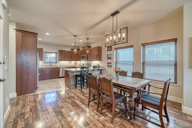 dining area featuring an inviting chandelier and light hardwood / wood-style floors