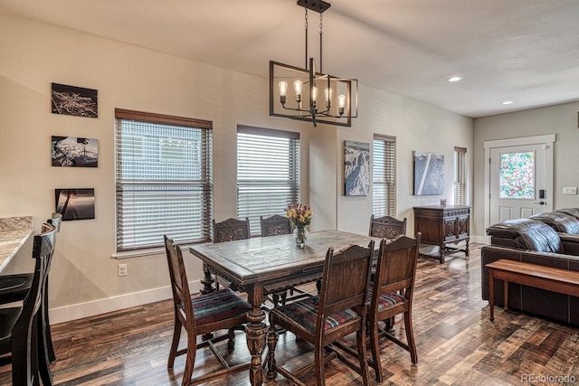 dining room with dark wood-type flooring and a chandelier